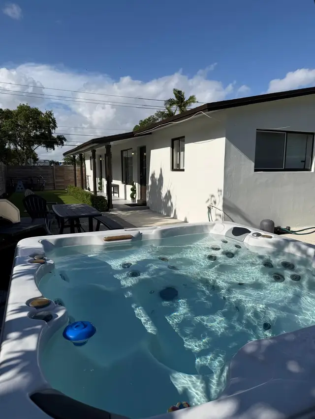 Hot tub on the patio at Even Keel, with an outdoor table behind