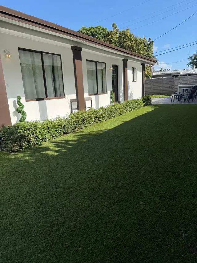 Turf yard and hedge along the side of Even Keel
