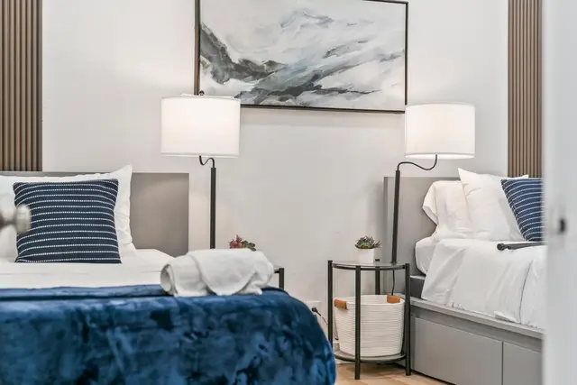Bedroom at Lily Pad with two twin beds, navy bedding and two lamps