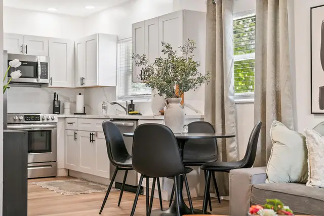 Kitchen at Lily Pad with stainless steel appliances and a round dining table with black chairs