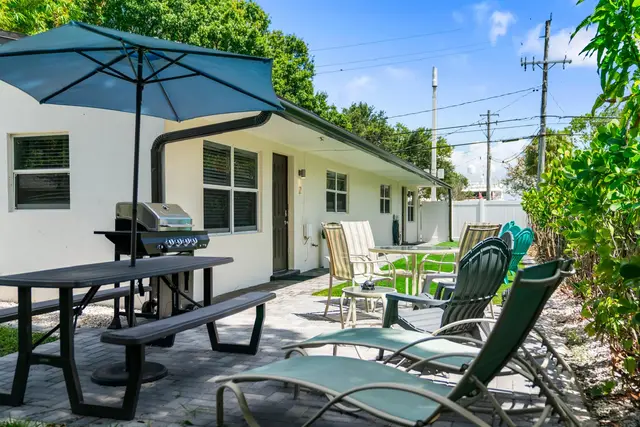 Patio at Lily Pad with a picnic table, an umbrella, a grill and lounge chairs